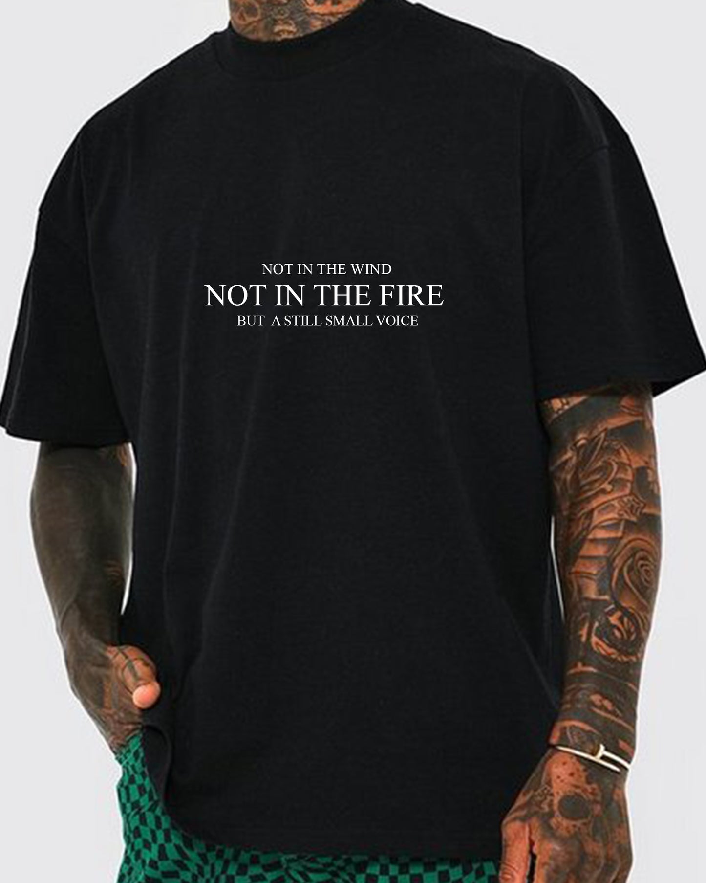 JESUS LOVES LAHAINA TEE - Front side: Not in the wind, not in the fire, but a still small voice - 1 Kings 19:11-12 | Support the victims from the 2023 Lahaina Fire with a Jesus Loves Lahaina T-shirt | Black tee with white screen print